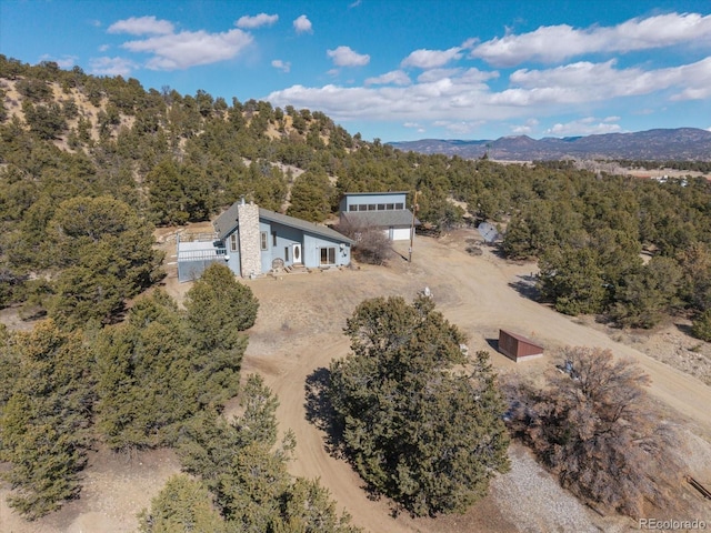 aerial view featuring a mountain view and a view of trees