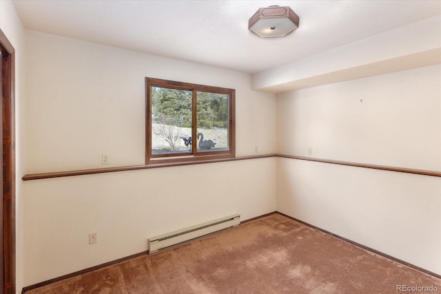 spare room with baseboard heating and carpet flooring