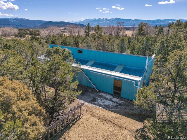 bird's eye view featuring a mountain view and a view of trees