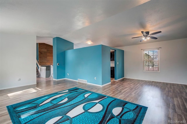 unfurnished living room featuring hardwood / wood-style flooring, lofted ceiling, and ceiling fan