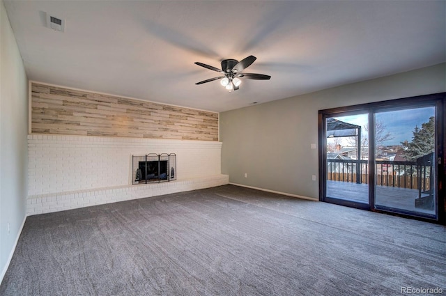 unfurnished living room with ceiling fan, carpet floors, and a fireplace