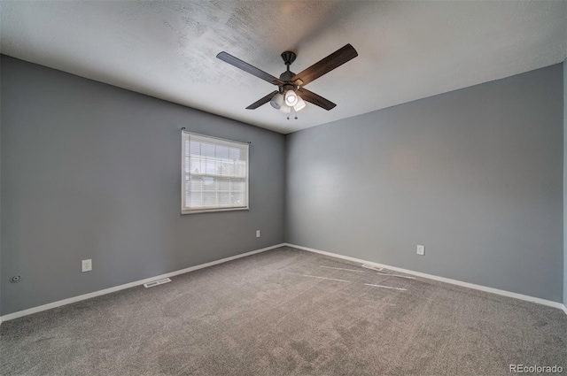 spare room with ceiling fan, carpet, and a textured ceiling