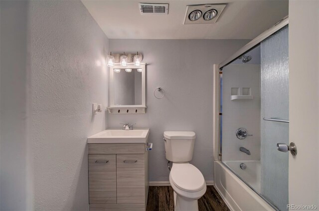 full bathroom featuring shower / bath combination with glass door, vanity, toilet, and wood-type flooring