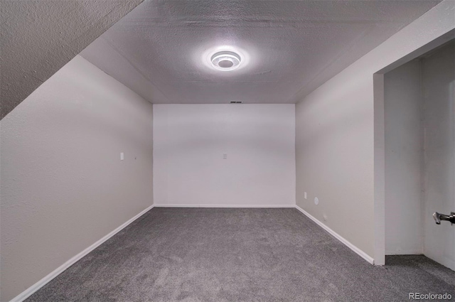 carpeted spare room with a textured ceiling