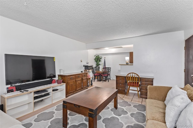 living room featuring a textured ceiling and light tile patterned floors