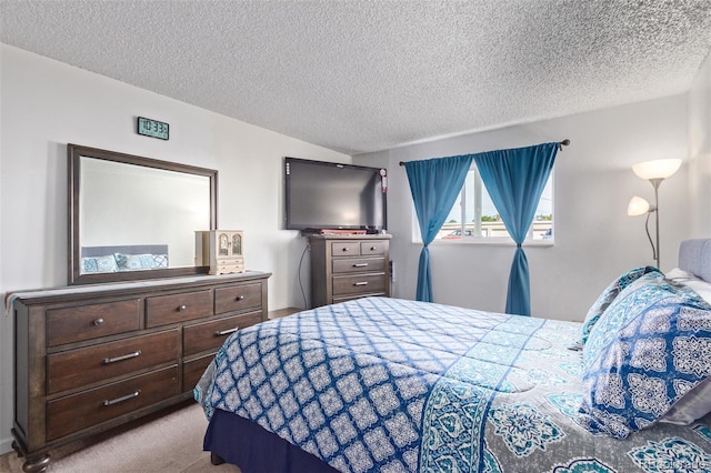 bedroom featuring a textured ceiling and light carpet