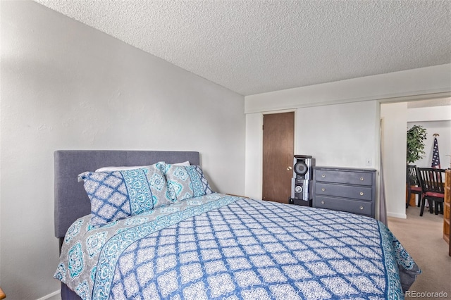 bedroom with a textured ceiling and carpet