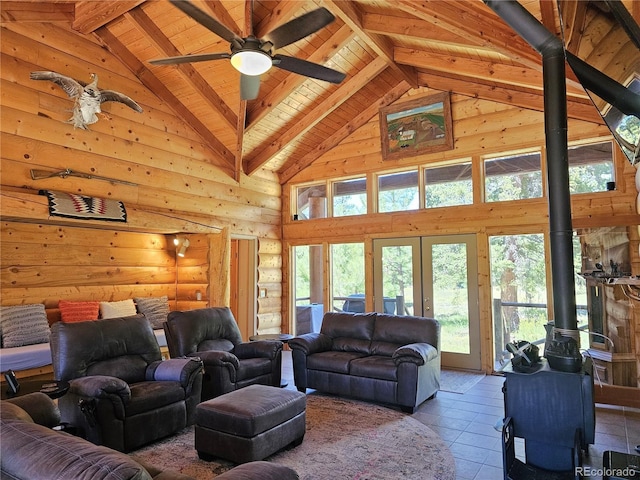 tiled living room with high vaulted ceiling, beamed ceiling, a wood stove, log walls, and wood ceiling