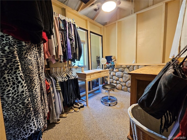 walk in closet featuring vaulted ceiling and carpet flooring