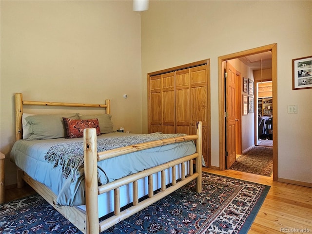 bedroom with wood-type flooring and a closet