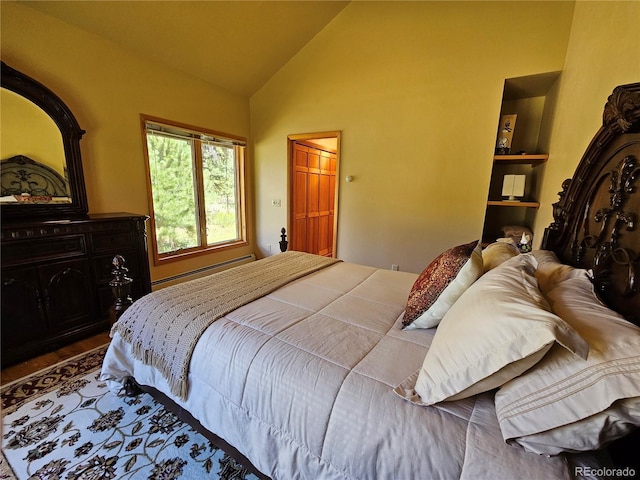 bedroom featuring baseboard heating and lofted ceiling