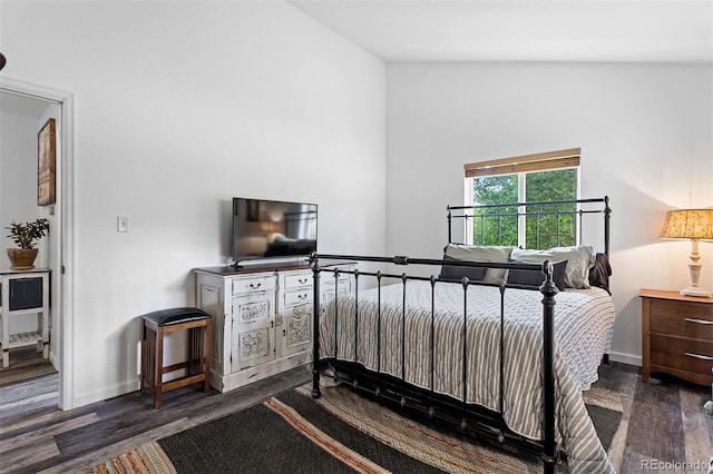 bedroom with dark hardwood / wood-style flooring