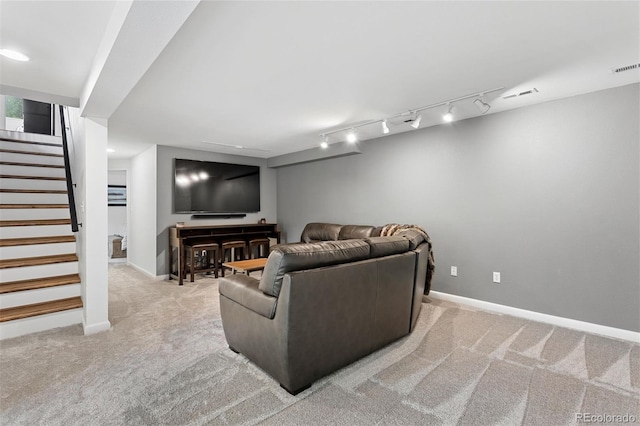 carpeted living room featuring track lighting