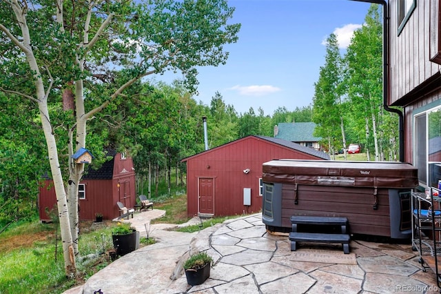 view of patio with a storage shed and a hot tub