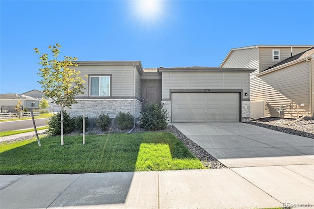 view of front of house with a garage and a front lawn