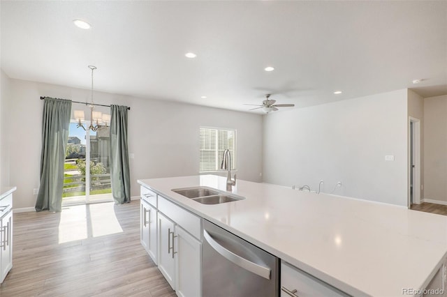 kitchen featuring hanging light fixtures, ceiling fan with notable chandelier, dishwasher, light wood-type flooring, and sink