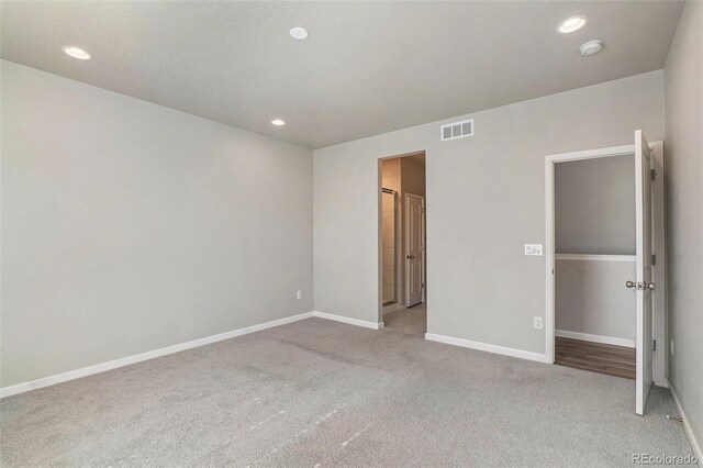 unfurnished bedroom featuring light colored carpet