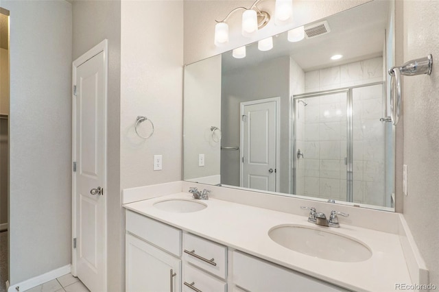 bathroom with tile patterned flooring, vanity, and a shower with shower door