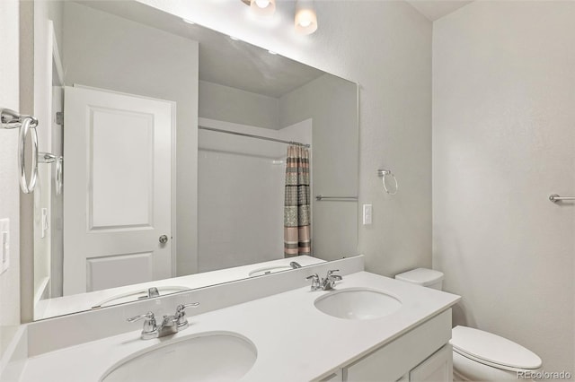 bathroom featuring walk in shower, vanity, and toilet