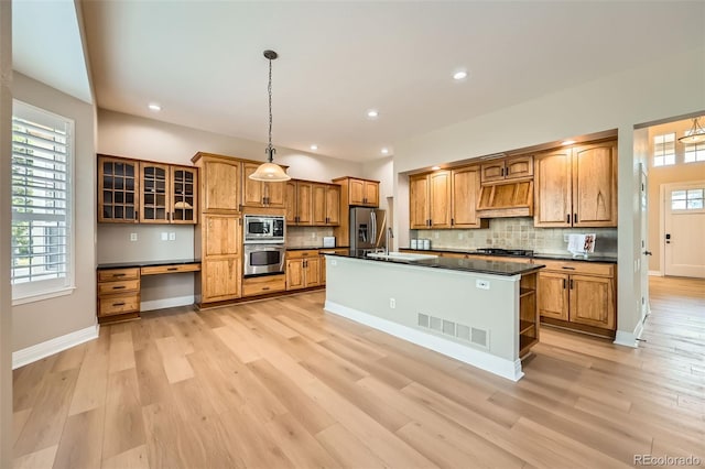 kitchen with dark countertops, appliances with stainless steel finishes, decorative backsplash, and visible vents
