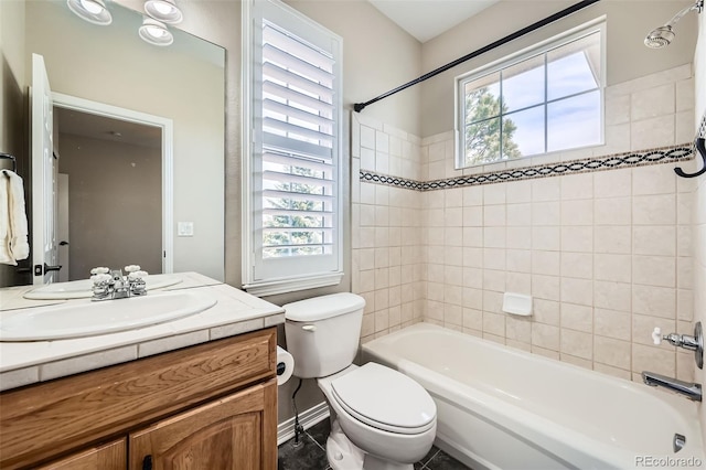 bathroom featuring toilet, shower / washtub combination, a healthy amount of sunlight, and vanity