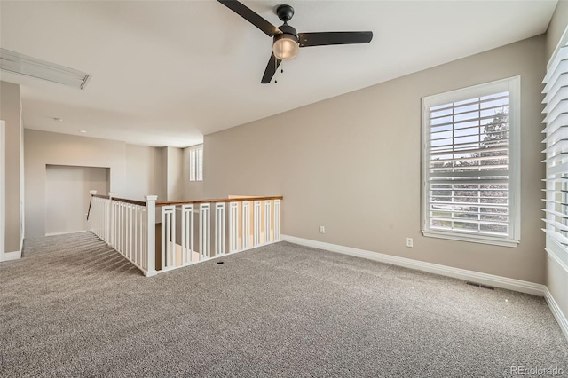 unfurnished room with carpet floors, ceiling fan, and baseboards