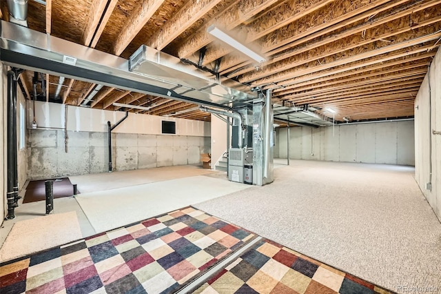 unfinished below grade area with heating unit and stairs