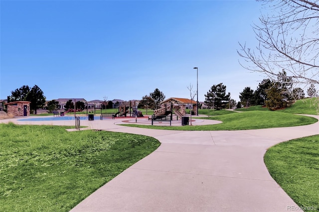 view of community featuring a lawn and playground community