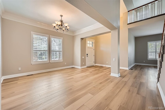 24487 E Frost Dr, Aurora, CO 80016 - foyer entrance featuring a chandelier, ornamental molding, light wood-type flooring, and baseboards