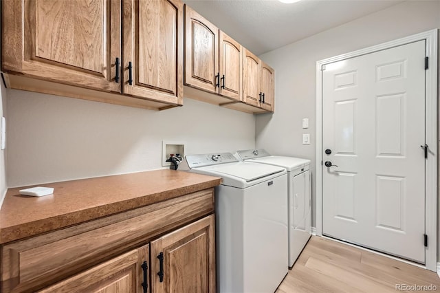 24487 E Frost Dr, Aurora, CO 80016 - laundry room with independent washer and dryer, cabinet space, and light wood-style flooring