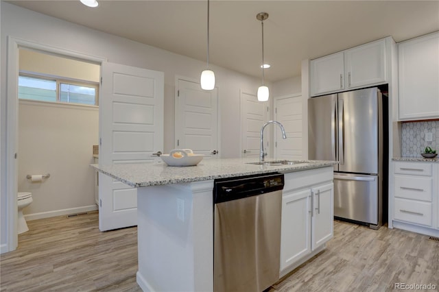 kitchen with white cabinetry, a center island with sink, and stainless steel appliances