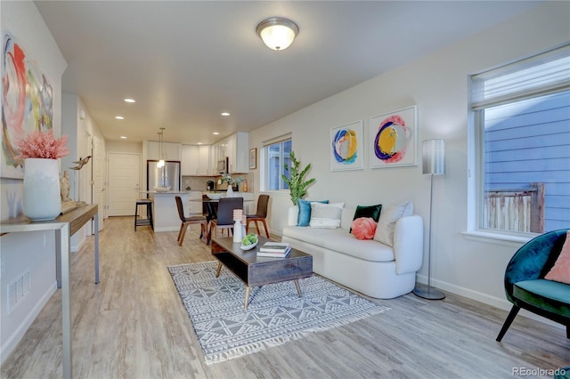 living room with light hardwood / wood-style floors