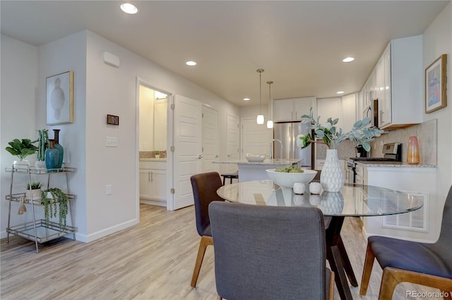 dining space with light hardwood / wood-style floors