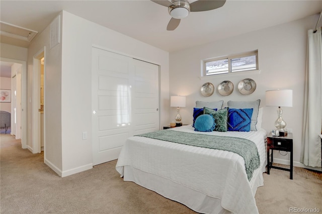 bedroom featuring a closet, light colored carpet, and ceiling fan