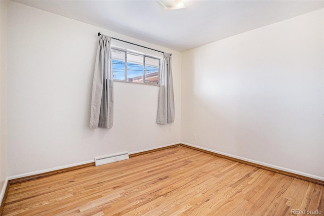 unfurnished room featuring wood finished floors and baseboards