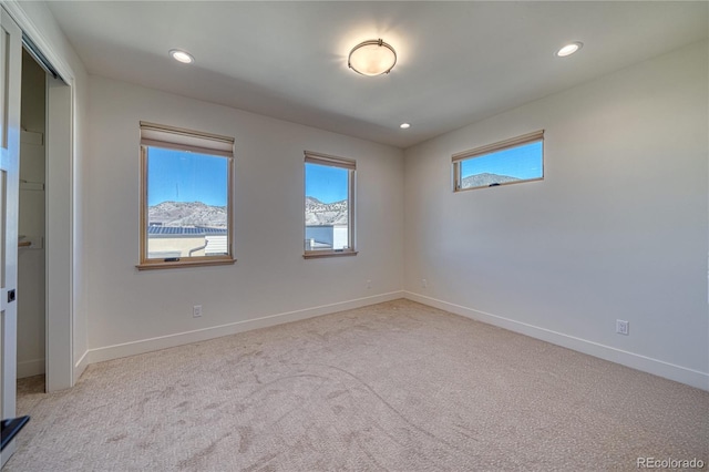 empty room with recessed lighting, baseboards, and light colored carpet