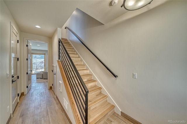 stairs featuring recessed lighting, wood finished floors, and baseboards