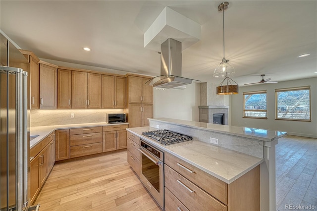 kitchen with light wood-style flooring, a kitchen island, open floor plan, stainless steel appliances, and island range hood