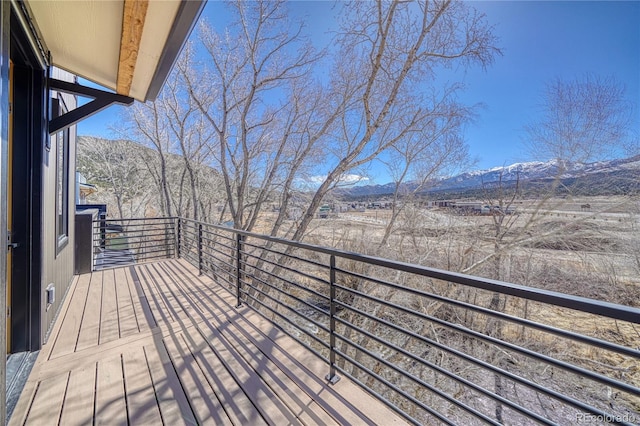 wooden terrace featuring a mountain view