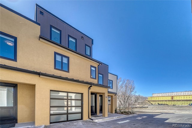 view of front of property featuring a garage and stucco siding