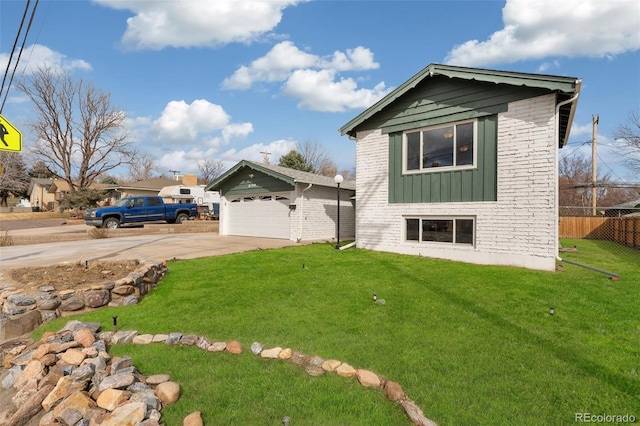 exterior space with fence, driveway, a yard, a garage, and board and batten siding