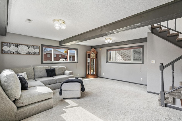 living area featuring stairway, baseboards, beam ceiling, a textured ceiling, and carpet flooring