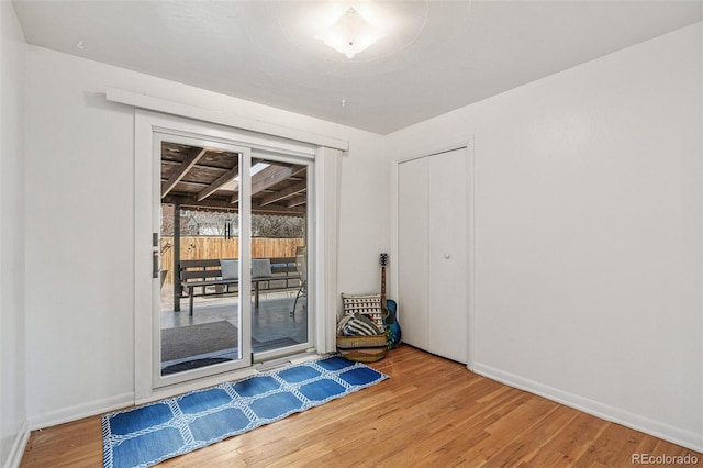 interior space with wood finished floors and baseboards