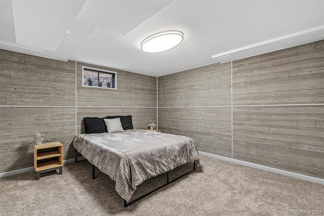 carpeted bedroom with wood walls