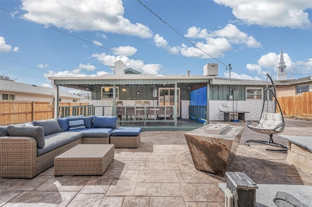 view of patio featuring an outdoor hangout area and fence