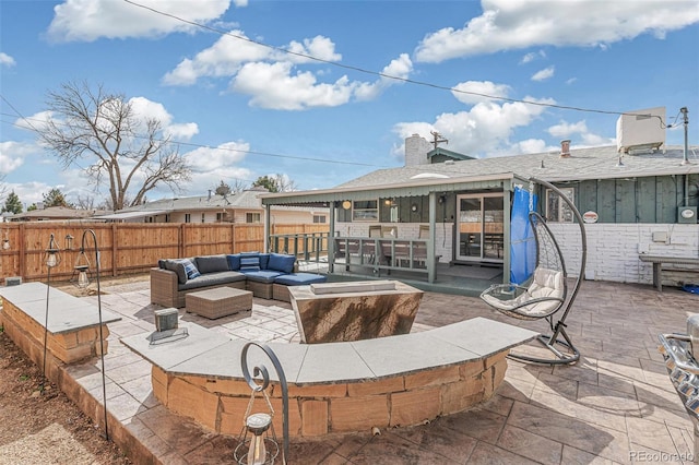 view of patio / terrace featuring an outdoor living space and fence