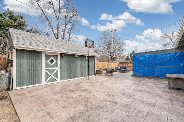 view of patio featuring an outdoor hangout area, an outdoor structure, and fence