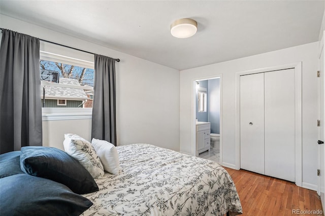 6190 Garrison St, Arvada, CO 80004 - bedroom featuring light wood-style flooring, ensuite bathroom, and a closet