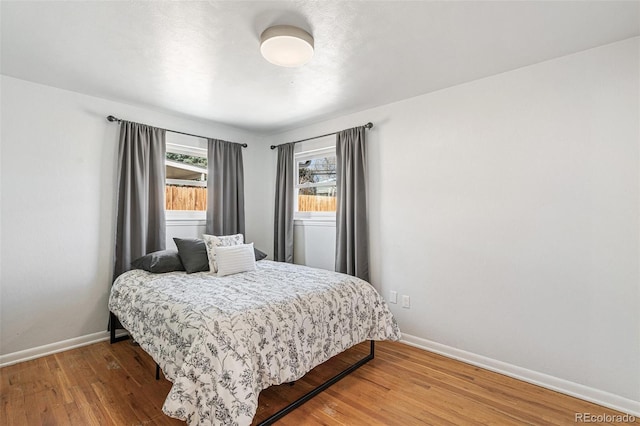 6190 Garrison St, Arvada, CO 80004 - bedroom with wood finished floors and baseboards