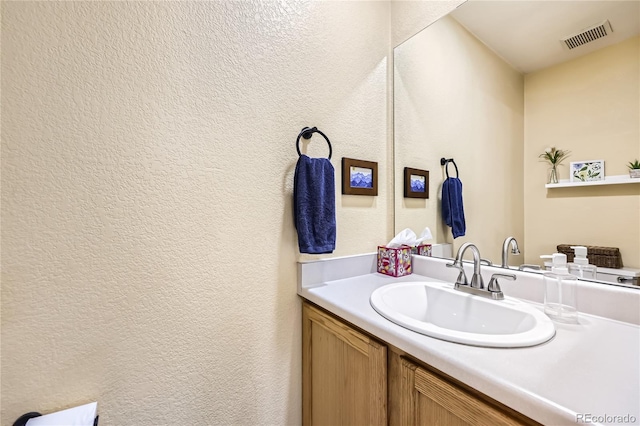 1974 E 102nd Cir, Thornton, CO 80229 - bathroom featuring a textured wall and vanity